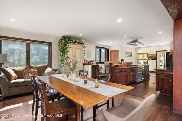 dining space with dark hardwood / wood-style floors and ornamental molding