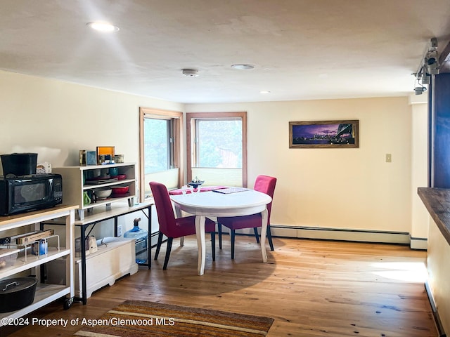 dining room featuring wood-type flooring and baseboard heating