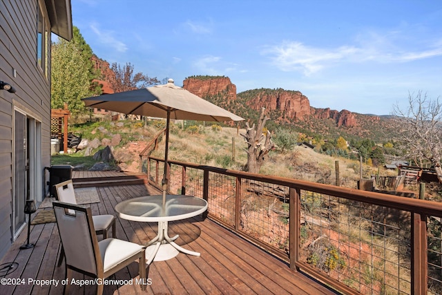 wooden deck featuring a mountain view