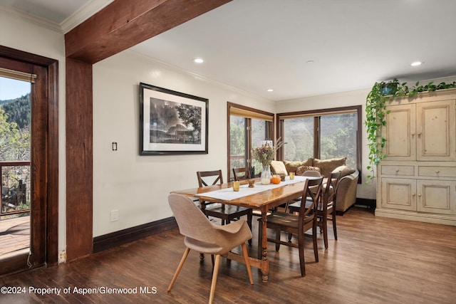 dining space with hardwood / wood-style flooring and crown molding