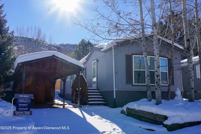 view of front of house featuring a mountain view and a carport