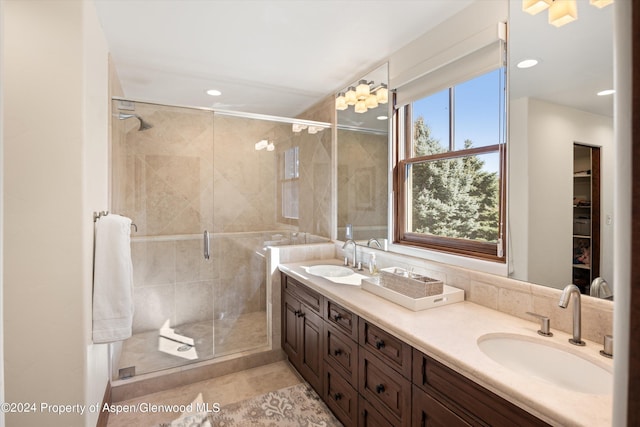 bathroom featuring tile patterned floors, vanity, and a shower with shower door