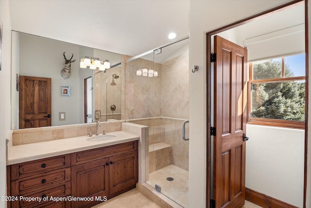 bathroom featuring vanity and a shower with door