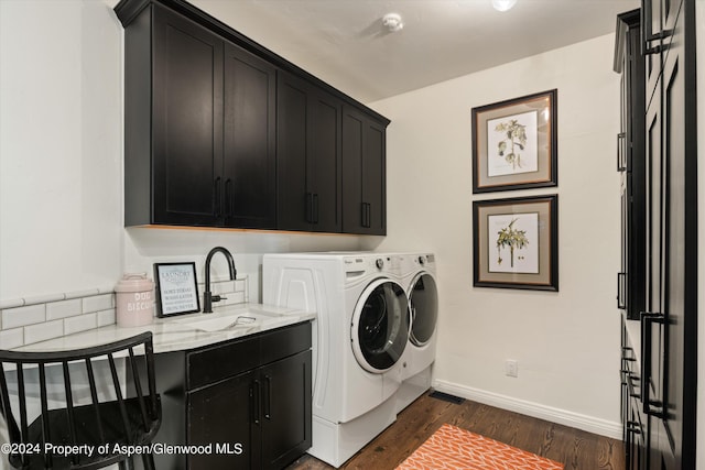 clothes washing area with cabinets, independent washer and dryer, sink, and dark wood-type flooring