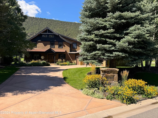 craftsman-style home with a mountain view and a front yard