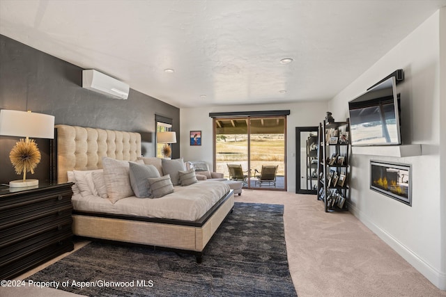 carpeted bedroom with access to outside and a wall mounted AC