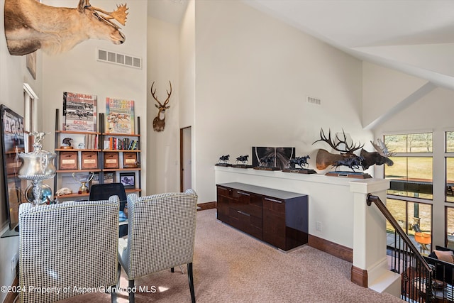 carpeted office featuring high vaulted ceiling