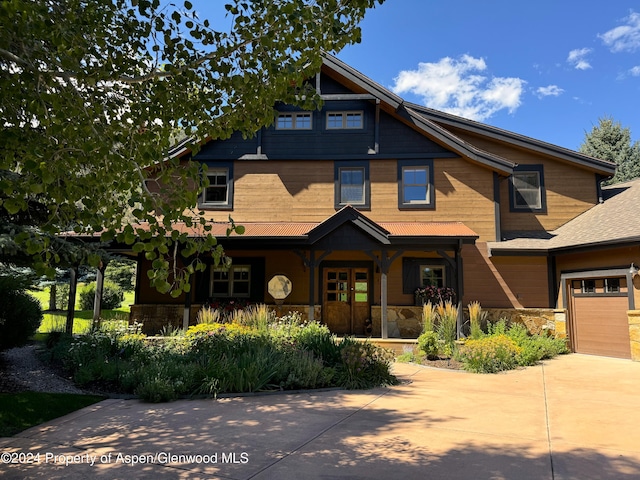 craftsman inspired home with covered porch and a garage