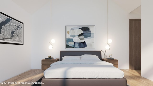 bedroom featuring wood-type flooring and vaulted ceiling