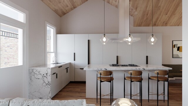 kitchen with wood ceiling, stainless steel gas cooktop, sink, decorative light fixtures, and white cabinets