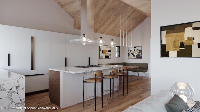 kitchen with wooden ceiling, light stone counters, hardwood / wood-style floors, pendant lighting, and a kitchen island