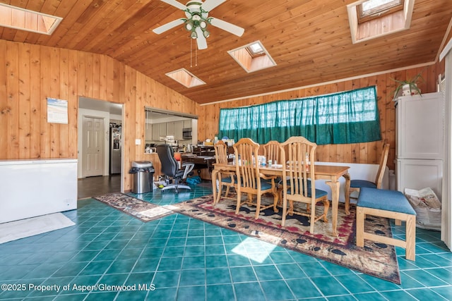 2201/2203 B St, Craig, CO 81625 - tiled dining area with a skylight, lofted ceiling, wooden walls, wood ceiling, and ceiling fan