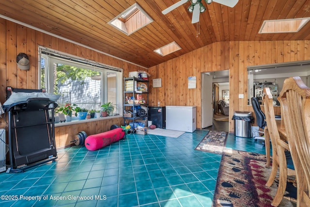 2201/2203 B St, Craig, CO 81625 - living room with a skylight, vaulted ceiling, wood walls, a ceiling fan, and tile patterned floors