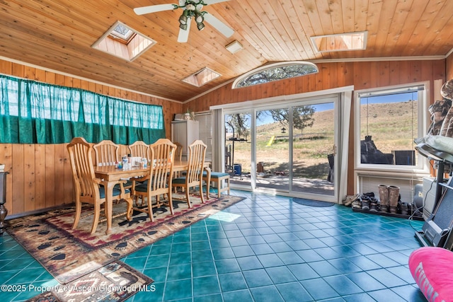 2201/2203 B St, Craig, CO 81625 - tiled dining area featuring a skylight, lofted ceiling, wood walls, a ceiling fan, and wooden ceiling