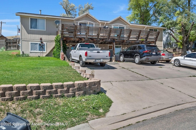 2201/2203 B St, Craig, CO 81625 - view of front of house with a front yard, a wooden deck, and concrete driveway