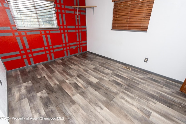 unfurnished room with hardwood / wood-style flooring