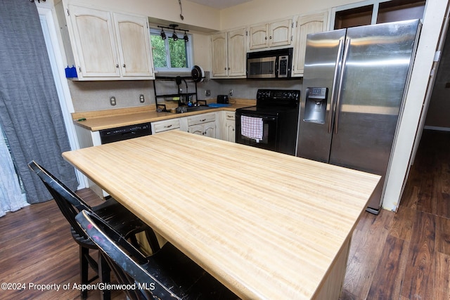 kitchen featuring black appliances and dark wood-type flooring