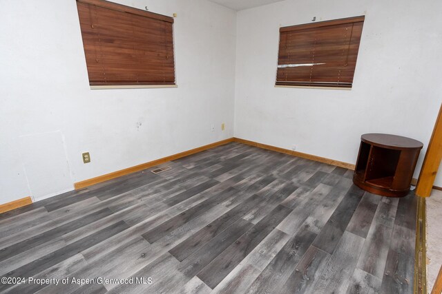 empty room featuring dark hardwood / wood-style flooring