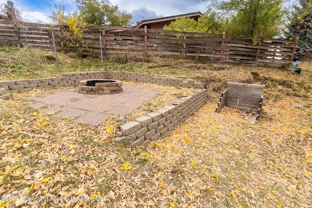 view of yard featuring a patio area and a fire pit