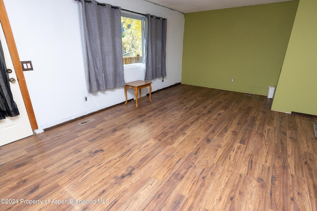 spare room with dark hardwood / wood-style floors