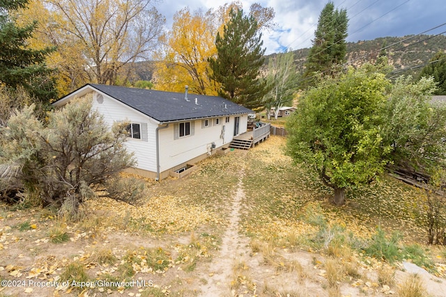 rear view of house with a wooden deck