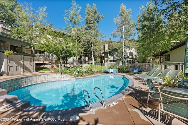 view of swimming pool featuring a patio area