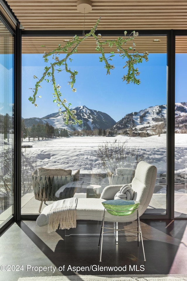 snow covered patio with a mountain view