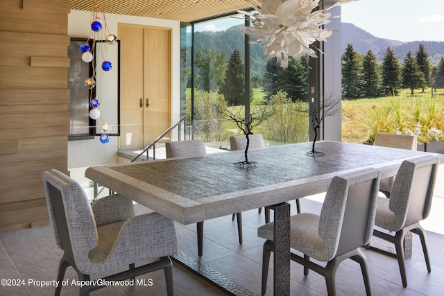 tiled dining area with a mountain view and wooden walls