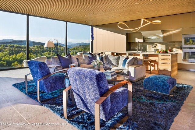 view of patio / terrace with a mountain view, an outdoor living space, sink, and an outdoor kitchen