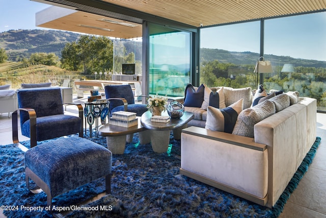 interior space with outdoor lounge area and a mountain view