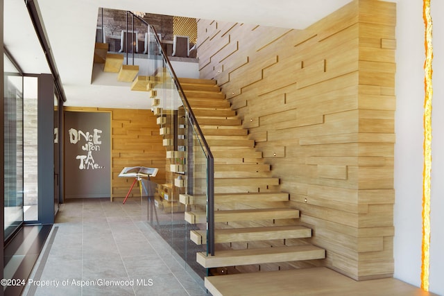 stairway with wood walls