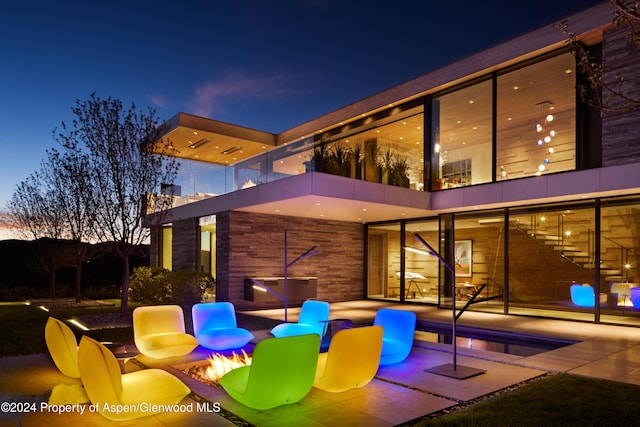 patio terrace at dusk with a pool