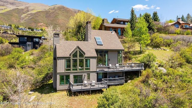 162 Bennett Bench Rd, Aspen, CO 81611 - back of house featuring a chimney, a deck with mountain view, board and batten siding, a balcony, and roof with shingles