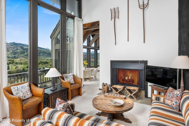 162 Bennett Bench Rd, Aspen, CO 81611 - carpeted living room featuring a high ceiling and a lit fireplace