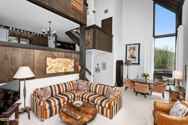 162 Bennett Bench Rd, Aspen, CO 81611 - carpeted living area with a towering ceiling, a chandelier, and plenty of natural light