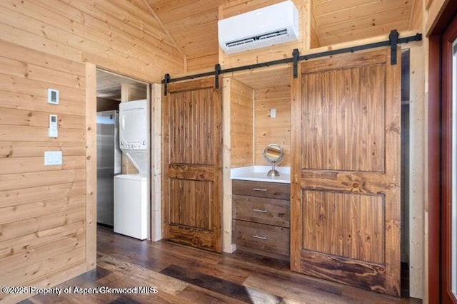 bathroom with stacked washer and dryer, lofted ceiling, wood walls, a wall mounted air conditioner, and hardwood / wood-style floors