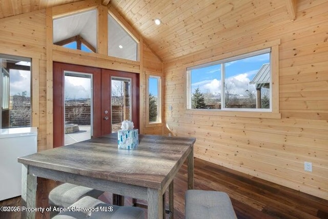 dining space with wood ceiling, high vaulted ceiling, wood-type flooring, french doors, and wood walls