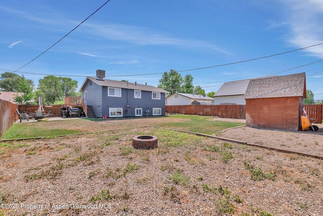 1186 Washington St, Craig, CO 81625 - fenced backyard with a fire pit and a wooden deck
