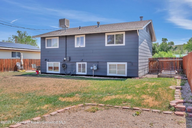 1186 Washington St, Craig, CO 81625 - back of house with a fenced backyard and roof with shingles