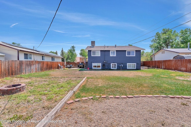 1186 Washington St, Craig, CO 81625 - back of house with a fire pit and a fenced backyard