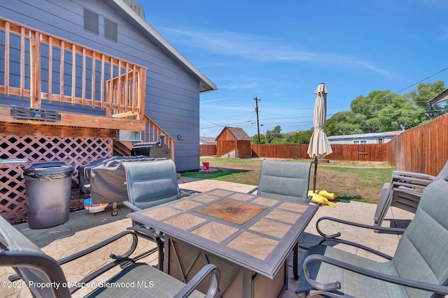 1186 Washington St, Craig, CO 81625 - fenced backyard with outdoor dining area, a shed, a patio area, and a wooden deck
