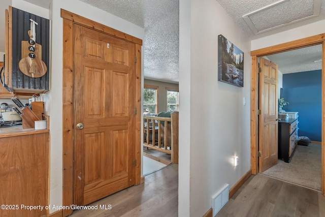 1186 Washington St, Craig, CO 81625 - hall with a textured ceiling and wood finished floors