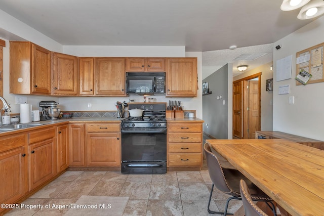 1186 Washington St, Craig, CO 81625 - kitchen featuring black appliances and brown cabinets