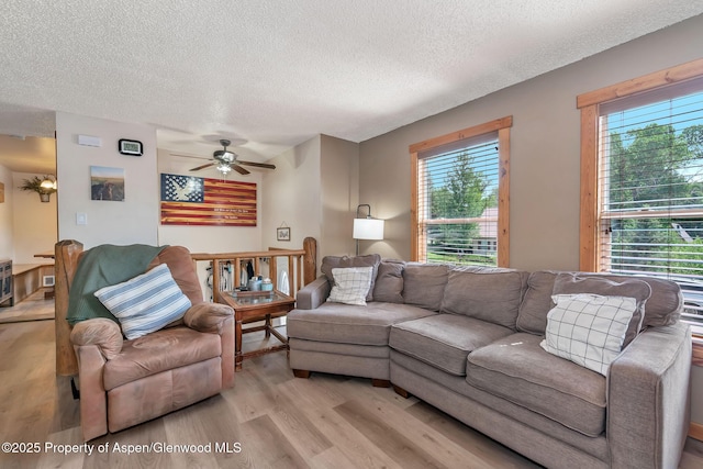 1186 Washington St, Craig, CO 81625 - living room featuring a textured ceiling, light wood-type flooring, plenty of natural light, and ceiling fan