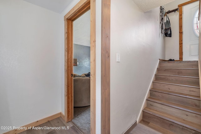 1186 Washington St, Craig, CO 81625 - stairway featuring baseboards and wood finished floors
