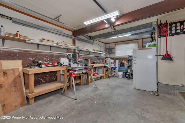 1186 Washington St, Craig, CO 81625 - garage featuring freestanding refrigerator and a workshop area