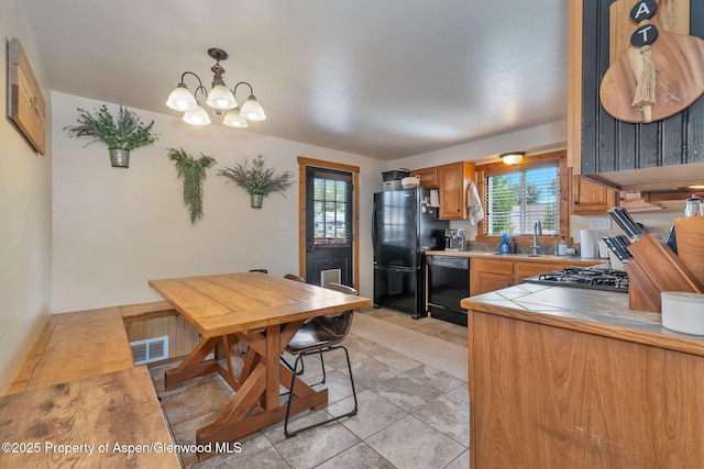 1186 Washington St, Craig, CO 81625 - kitchen featuring black appliances, healthy amount of natural light, a chandelier, and tile countertops