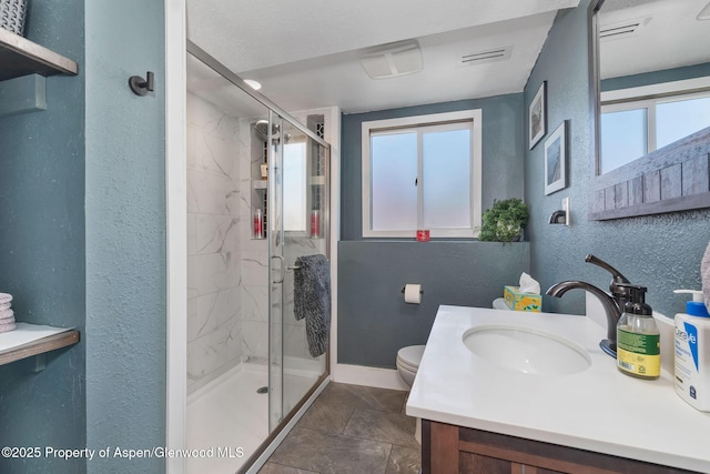 1186 Washington St, Craig, CO 81625 - bathroom featuring a textured wall, healthy amount of natural light, a marble finish shower, and vanity