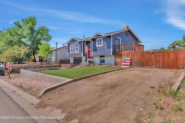 1186 Washington St, Craig, CO 81625 - bi-level home with brick siding, a garage, and dirt driveway