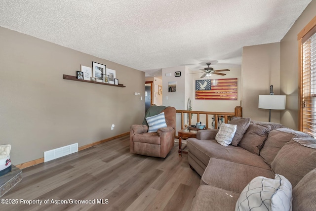 1186 Washington St, Craig, CO 81625 - living room featuring wood finished floors, a textured ceiling, and a ceiling fan
